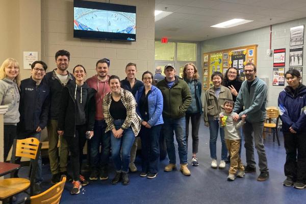 Postdoctoral fellows in lobby outside of skating rink